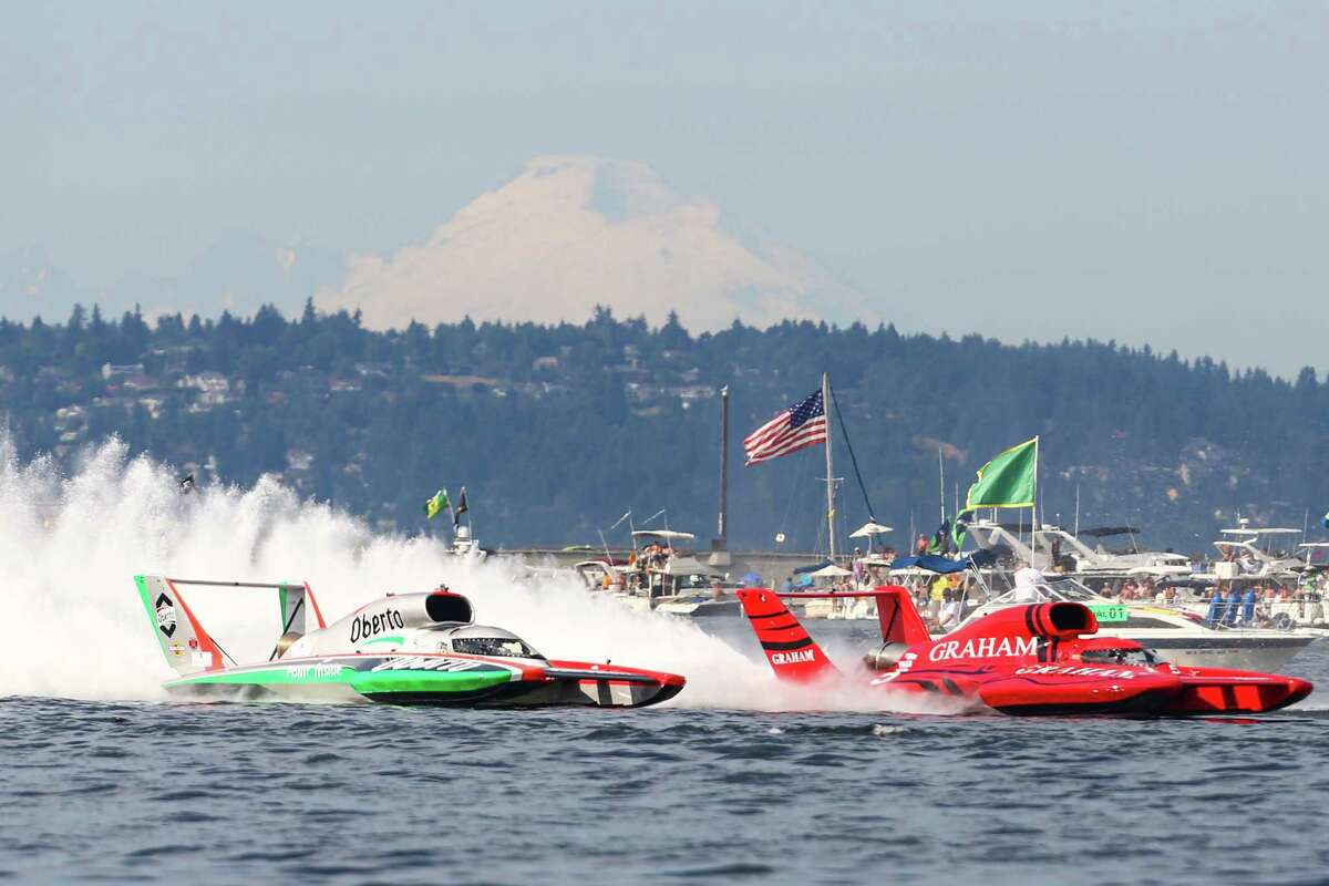 The U-1 Oberto and the U-5 Graham Trucking have a fierce battle for the lead in the championship race during Seafair 2015. Oberto was penalized during the race and the Graham Trucking boat won the race. Seafair, the traditional summer Seattle festival, brings hydroplane boats to Lake Washington and aircraft to the skies above for the weekend's Boeing Air Show. Photographed on Sunday, August 2, 2015.