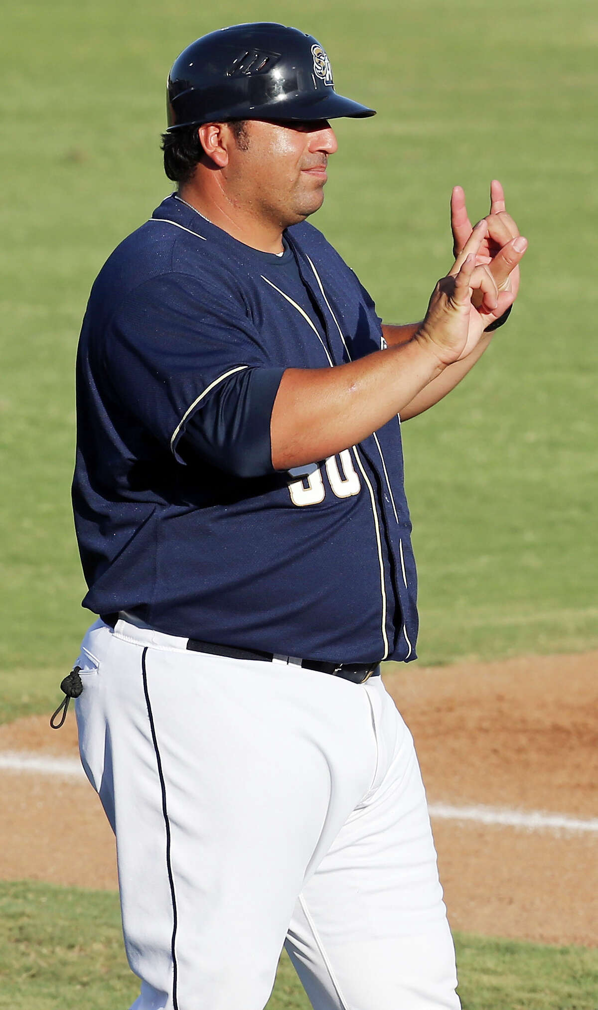 Missions manager Rod Barajas signals a play against the Tulsa Drillers Saturday July 11, 2015 at Wolff Stadium.