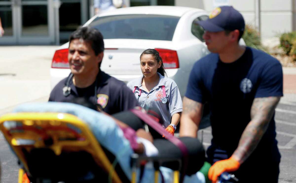 Edison High School student Gisel Garcia, a student in the fire sciences magnet program, works Tuesday July 28, 2015, with an SAFD EMT crew as they treat a patient.