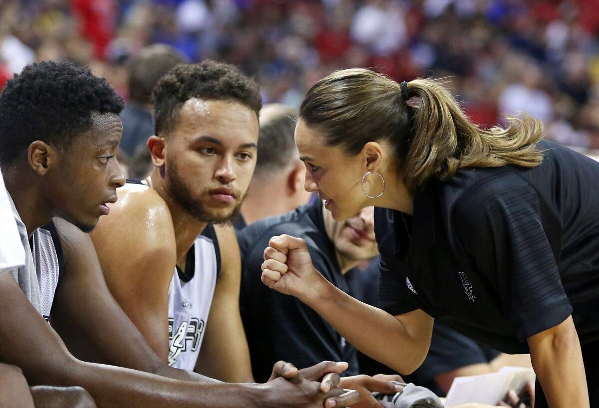 FILE - In this July 11, 2015, file photo, NBA Summer League head coach Becky Hammon talks with San Antonio Spurs' Kyle Anderson, left, and Cady Lalanne during an NBA summer league basketball game against the New York Knicks in Las Vegas. Becky Hammon dreamed of playing in the NBA when she was young. She never got a chance to make that happen. Now though, she's giving girls hope of a chance to coach in the NBA. (AP Photo/Ronda Churchill, File)