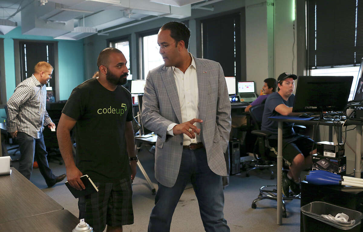 Geekdom director Lorenzo Gomez (left) shows U.S. Rep. Will Hurd, R-Helotes, some of the member tech companies, including WP Engine, a WordPress hosting company. Hurd was visiting with the tech community for input Monday.