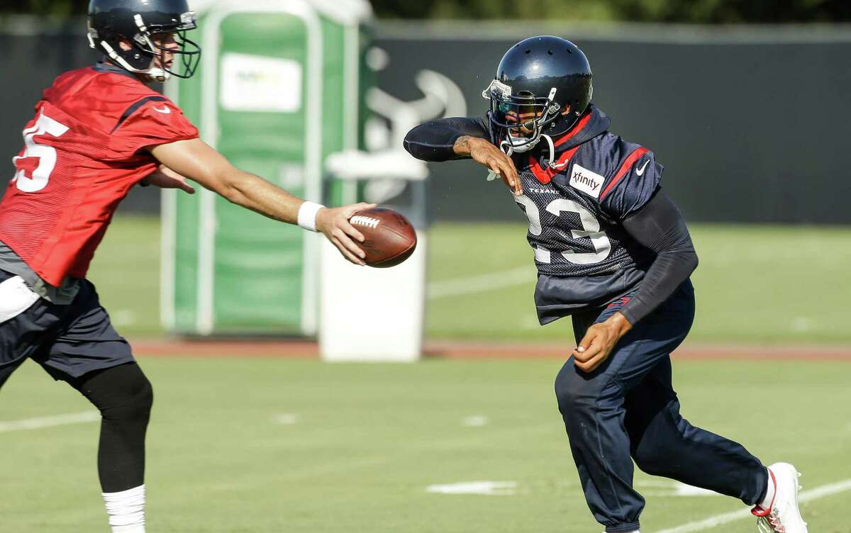 Houston Texans running back Arian Foster (23) takes a handoff from quarterback Ryan Mallett (15) during Texans training camp at the Methodist Training Center Sunday, Aug. 2, 2015, in Houston.
