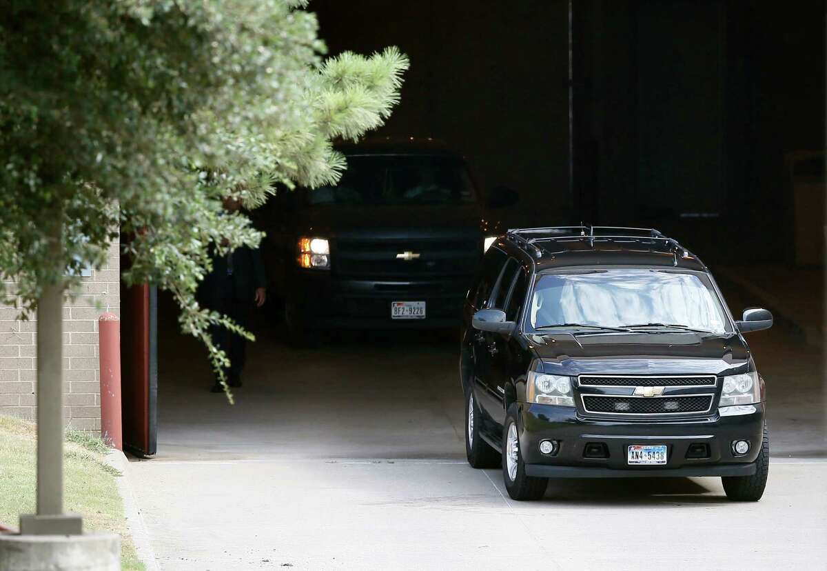 A black SUV carrying Texas Attorney General Ken Paxton and others departs the Collin County jail Monday, Aug. 3, 2015, in Plano, Texas. (AP Photo/Tony Gutierrez)