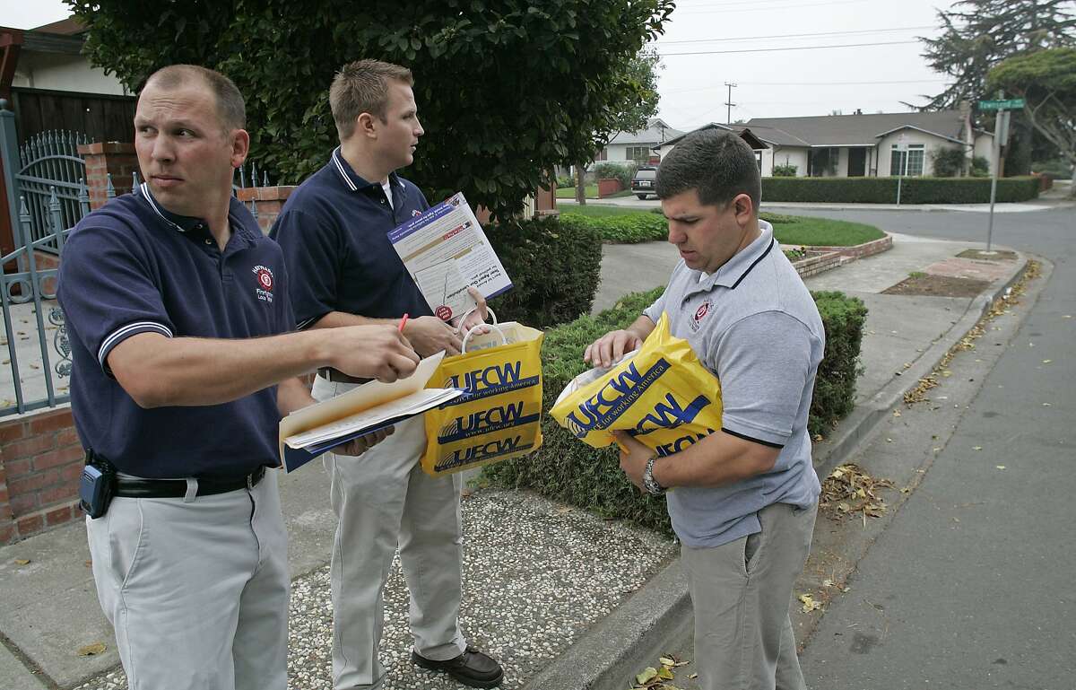 In this 2005 file photo, Hayward firefighter Garrett Contreras, left, and firefighters Jason Livermore and Frank Saiz, plot out their course of action for talking with residents about several propositions on the ballot. Contreras, now Hayward's fire chief, was suspended but allowed to continue with his job after a number of behavioral issues that include drinking while on call.