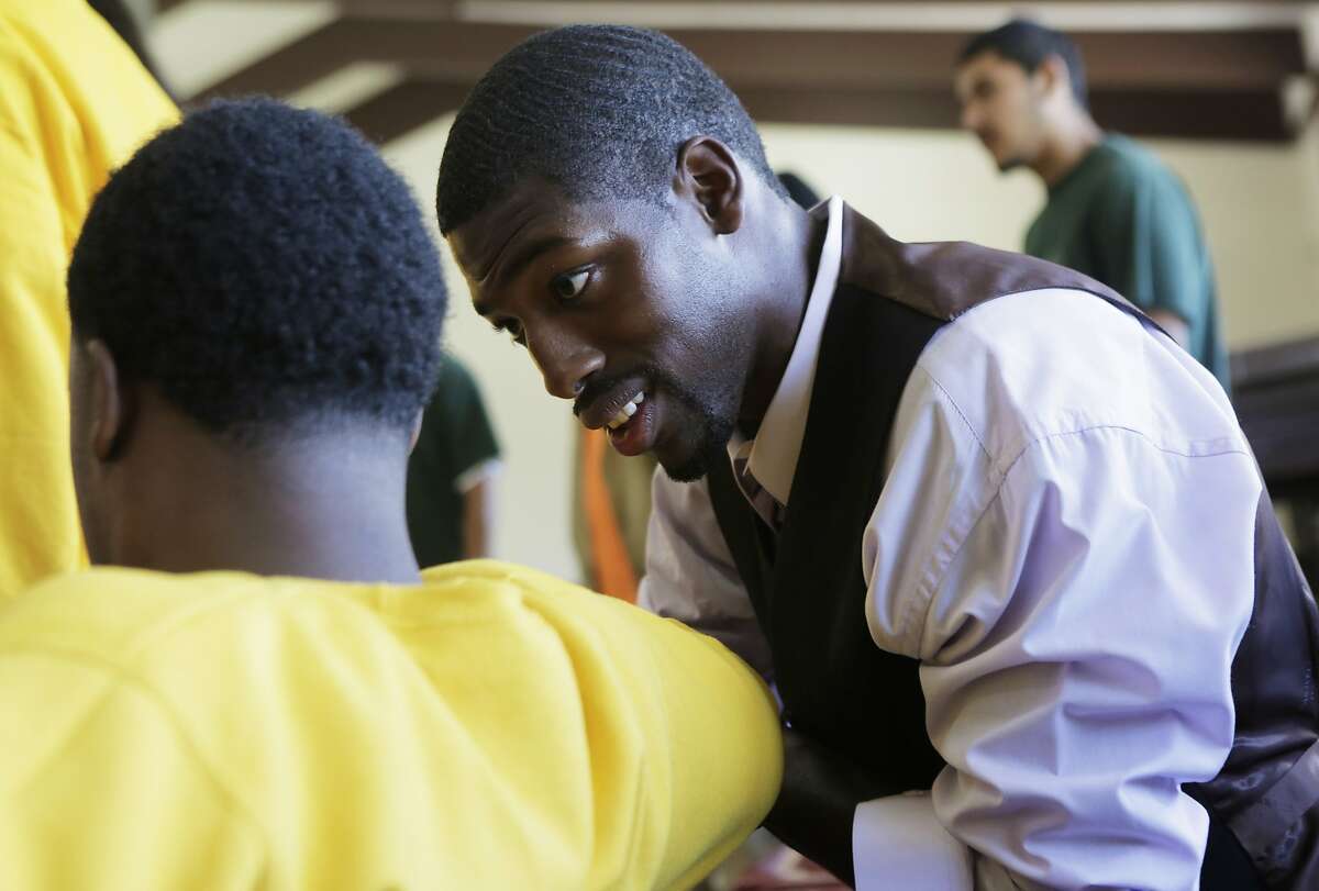 Juvenile Justice Delinquency Prevention Commissioner Tony Robinson speaks to a young man of Camp Sweeney during the morning pep rally or "Harambee" as a part of Freedom School, a summer program at Camp Sweeney Academic Center, in San Leandro, Ca. on Tuesday, Aug. 4, 2015.