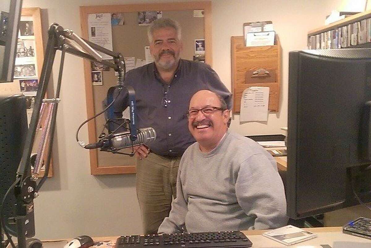 Dante Betteo, standing, general manager at KCSM radio, with DJ Jesse "Chuy" Varela.