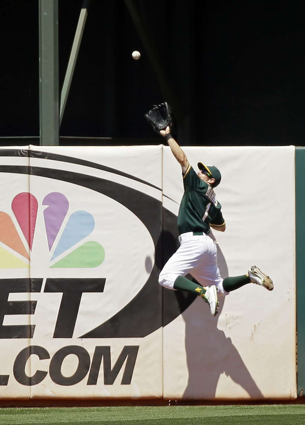 Oakland Athletics center fielder Billy Burns makes a leaping catch at the wall on a fly ball hit by the Baltimore Orioles' Adam Jones during the sixth inning of a baseball game, Wednesday, Aug. 5, 2015, in Oakland, Calif. (AP Photo/Eric Risberg)
