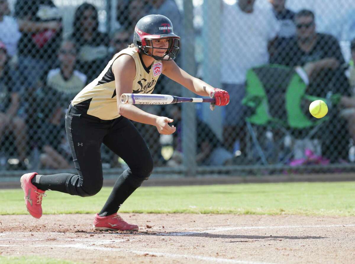 Seguin’s Kaylyn Cordero bunts against Greater Helotes in the championship game of the 2015 Little League Softball Southwest Region Tournament in Waco on Wednesday, Aug. 5, 2015. Seguin held off Helotes to win, 6-4, and moved on to play in the World Series tournament in Portland, Oregon.