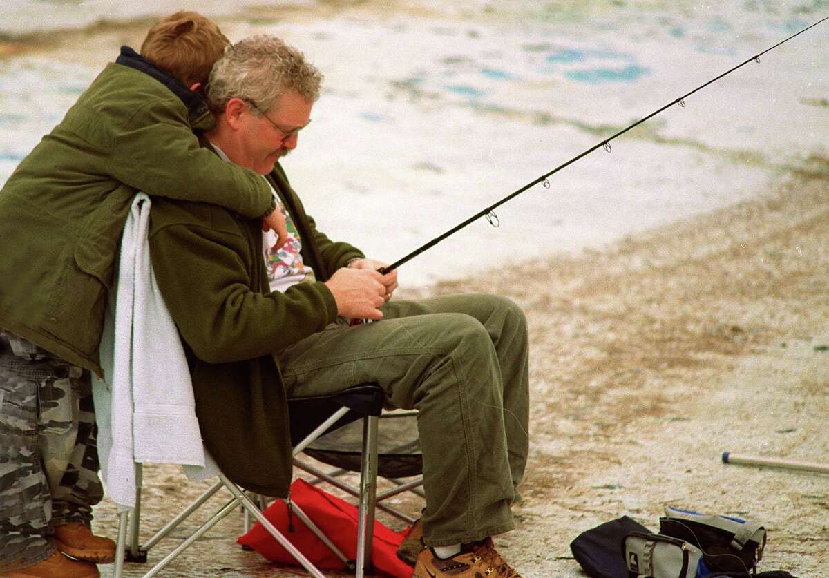 6 yr old Kaleb Rowe of Sandy Hook gives his Dad , Art, a hug at the Fishing Derby at Treadwell Park, in Newtown.