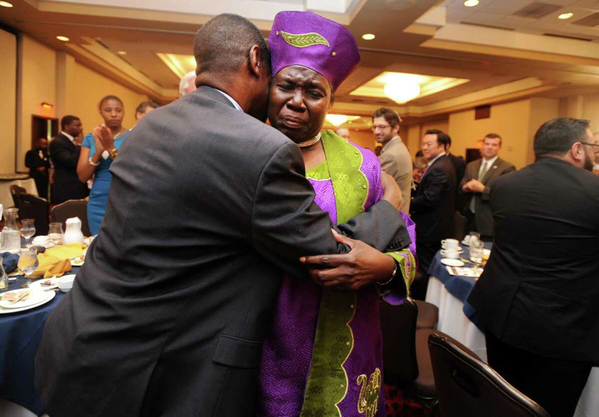 The Rev. Mary McBride Lee hugs the Rev. Carl McCluster, of Shiloh Baptist Church on Thursday during a ceremony at the Bridgeport Holiday Inn to mark the signing of the 1965 Voting Rights Act. McBride Lee was honored at the event for her participation in the historic march in Selma, Ala., in 1965.