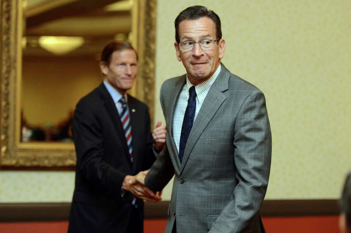 Gov. Dannel P. Malloy shakes hands with Sen. Richard Blumenthal Thursday, Aug. 6, 2015, during a ceremony at the Bridgeport Holiday Inn to mark the signing of the 1965 Voting Rights Act.