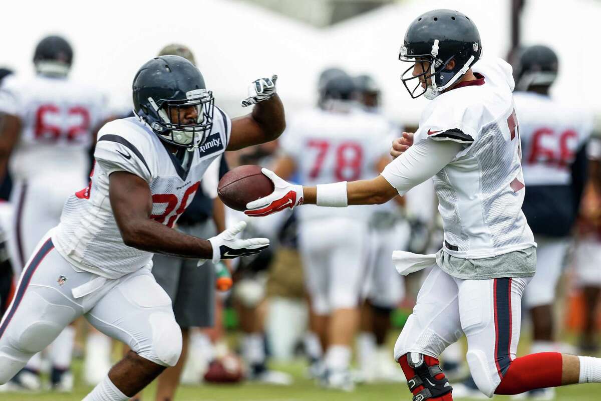 Houston Texans running back Kenny Hilliard (38) takes a handoff from quarterback Brian Hoyer during Texans training camp with the Washington Redskins at the Bon Secours Training Center on Thursday, Aug. 6, 2015, in Richmond, Va.