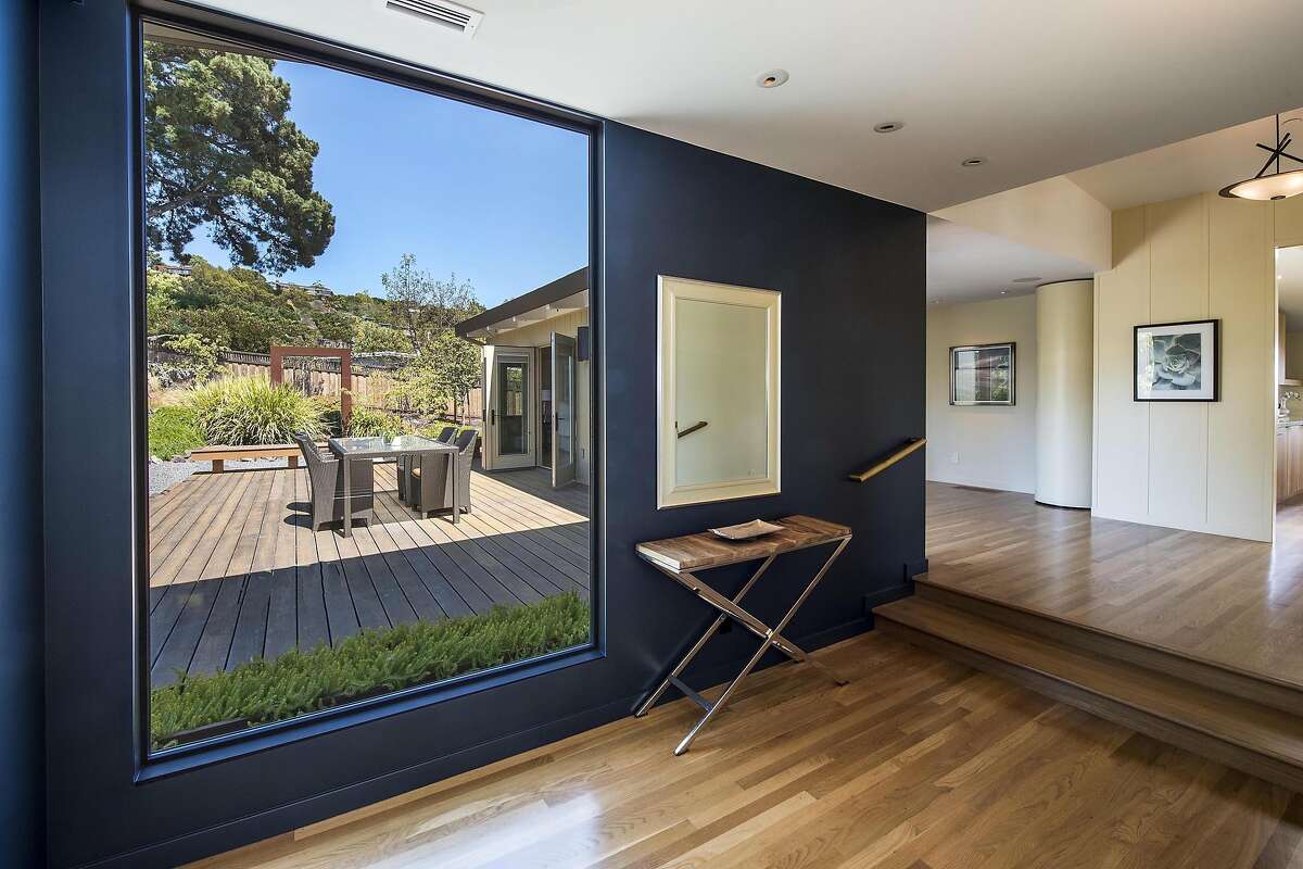 An oversized window near the laundry room looks out at the deck and drought-tolerant backyard.