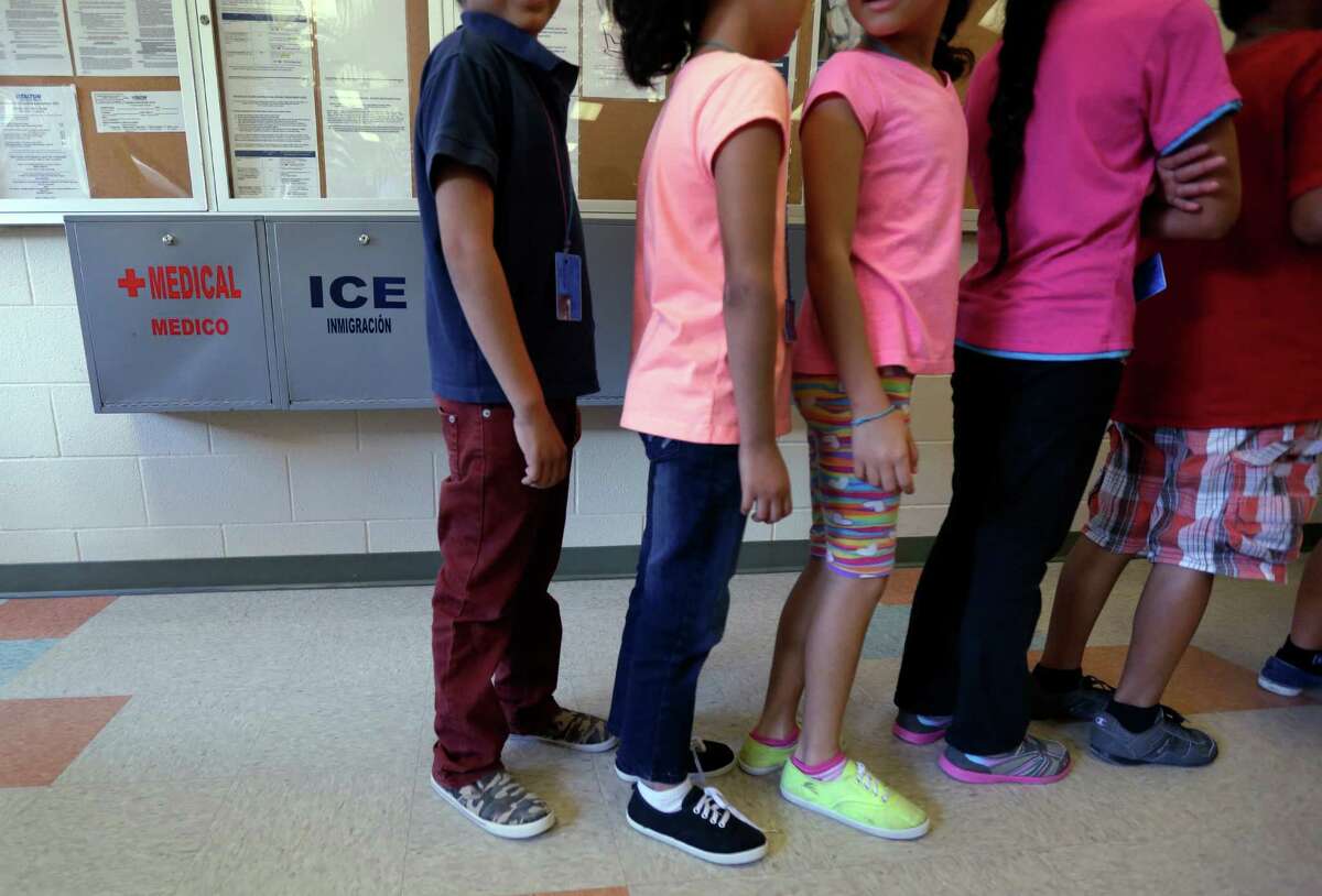 In this Sept. 10, 2014 file photo, detained immigrant children line up in the cafeteria at the Karnes County Residential Center, a temporary home for immigrant women and children detained at the border, in Karnes City. The private owners of the facility are seeking to have it licensed as a child-care facility.