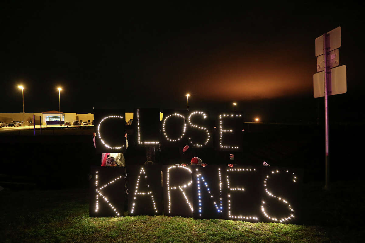 Members of UltraViolet and GetEQUAL, women and LBBTQ groups, hold lighted signs in front of the U.S Immigration and Customs Enforcement Karnes County Residential Center to protest allegation of sexual abuse against immigrants at the facility, Thursday, Jan. 22, 2015. The group presented 40,000 petitions calling of the closure of the facility and an investigation into allegations of sexual assaults of women detained at the center. Patrick Fierro, of GetEQUAL Texas said of the detention centers, "we won't stop until they are all closed."