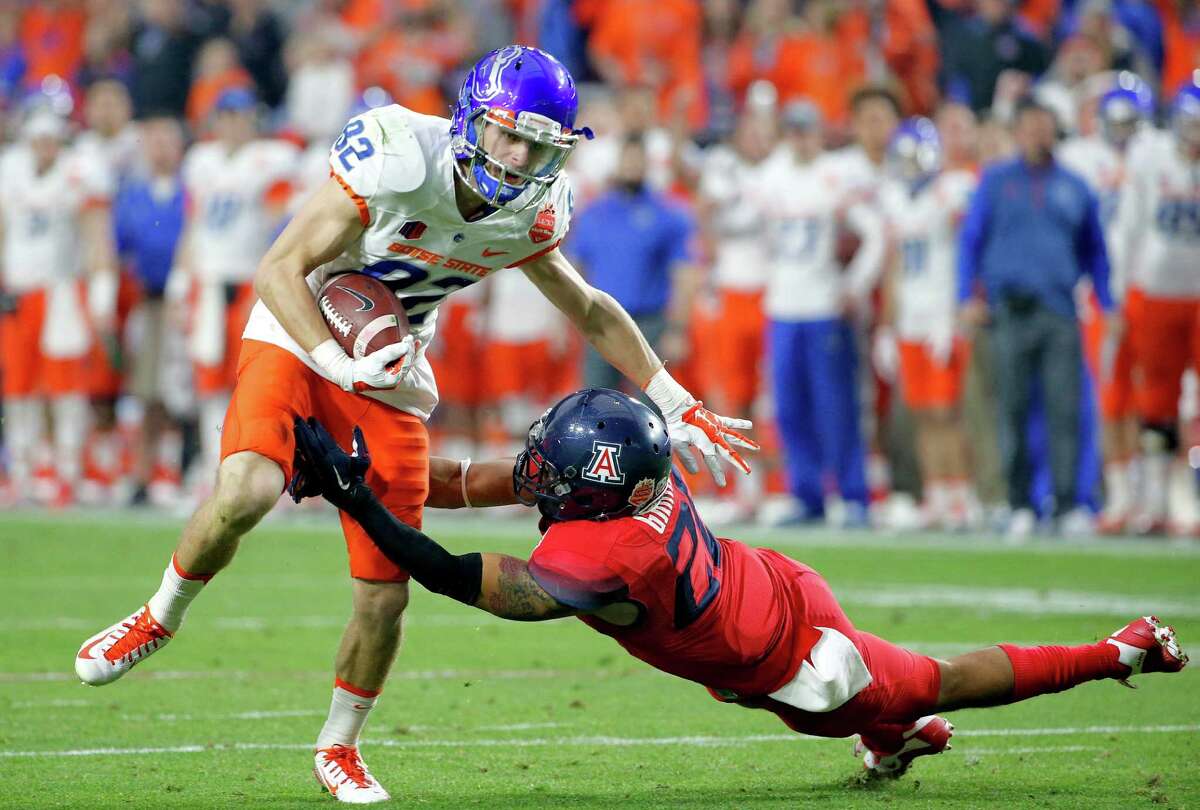 Boise State wide receiver Thomas Sperbeck (82) is hit by Arizona cornerback Jarvis McCall Jr. during the first half of the Fiesta Bowl NCAA college football game, Wednesday, Dec. 31, 2014, in Glendale, Ariz.