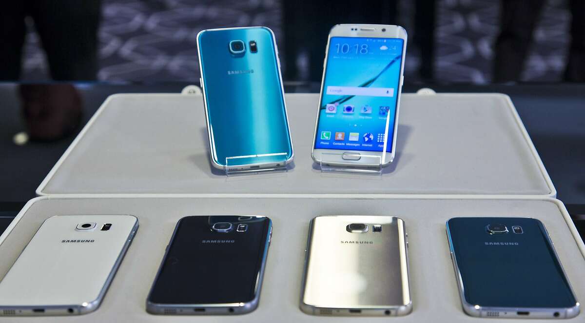 FILE- In this Feb. 23, 2015, file photo, two new Samsung phones, Galaxy S6, top left, and Galaxy S6 Edge, to right, are on display with choice of color selections at a special media preview in New York. Orders for Samsung's Galaxy S 6 phones start Saturday, March 28, 2015, with delivery around April 10. (AP Photo/Bebeto Matthews, File)