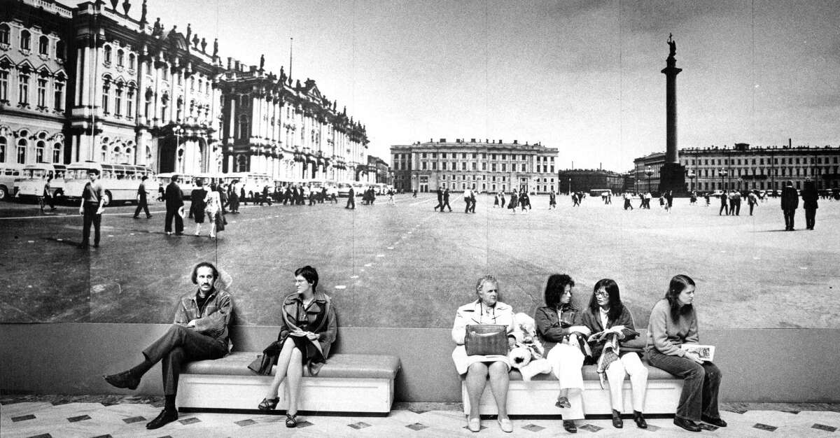 Top: People rest in front of a photo of the Winter Palace in Leningrad during a major exhibit of Russian art at the Palace of the Legion of Honor museum in 1976. Above: A shark is on display near the Steinhart Aquarium at the old Academy of Sciences.