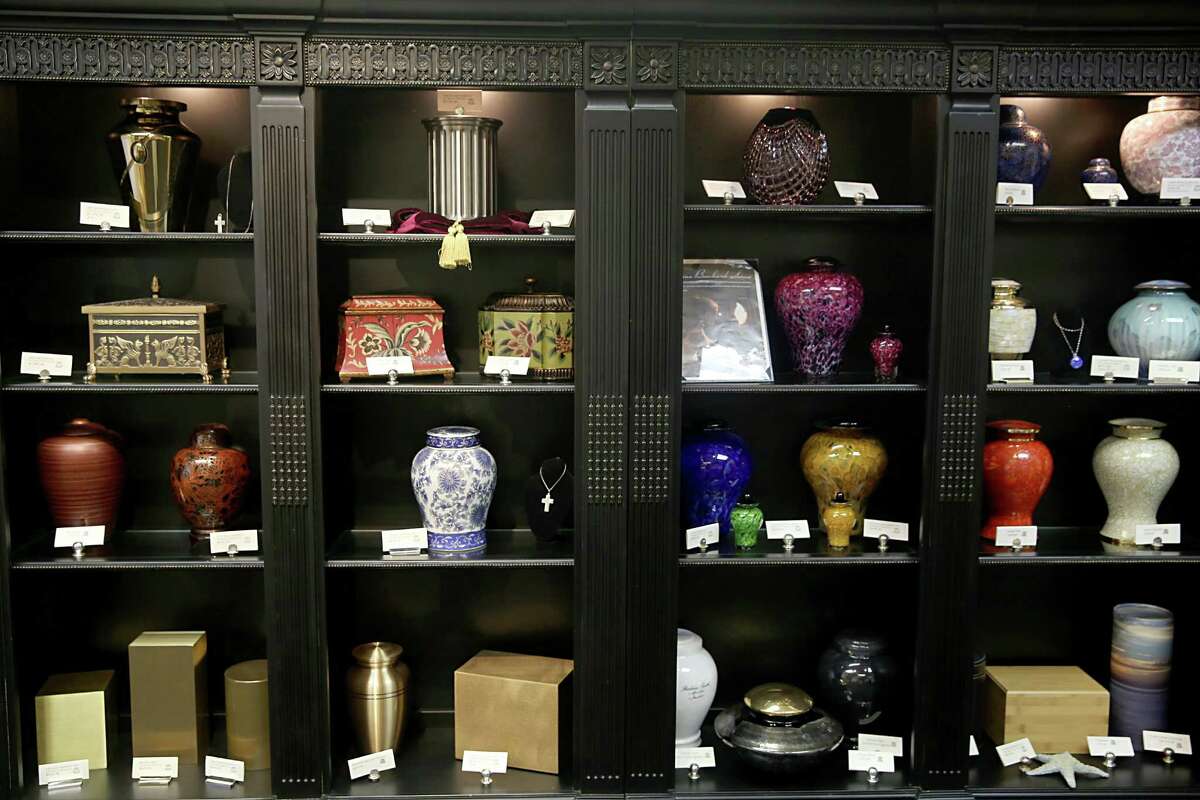 The Geo. H. Lewis & Sons Funeral Home has a number of urns on display for families thinking about cremation over traditional burials.