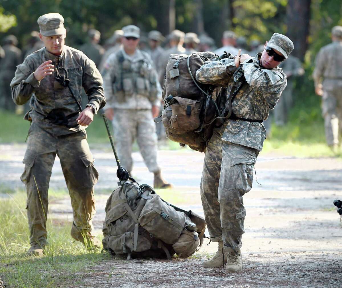 A female Army Ranger student lifts a rucksack onto her back on Tuesday, Aug. 4, 2015, at Camp James E. Rudder on Eglin Air Force Base, Fla. Two out of 19 females have made it to the final phase of Army Ranger training which ends at Camp James E. Rudder on Eglin Air Force Base. (Nick Tomecek/Northwest Florida Daily News via AP)