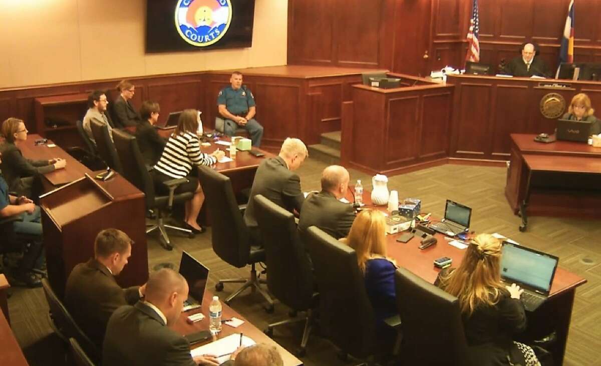 In this image made from Colorado Judicial Department video, James Holmes, top left in tan shirt, watches as Judge Carlos A. Samour, Jr., top right, prepares to read the jury's sentencing verdict in the Colorado theater shooting trial in Centennial, Colo., Friday, Aug. 7, 2015. (Colorado Judicial Department via AP, Pool)