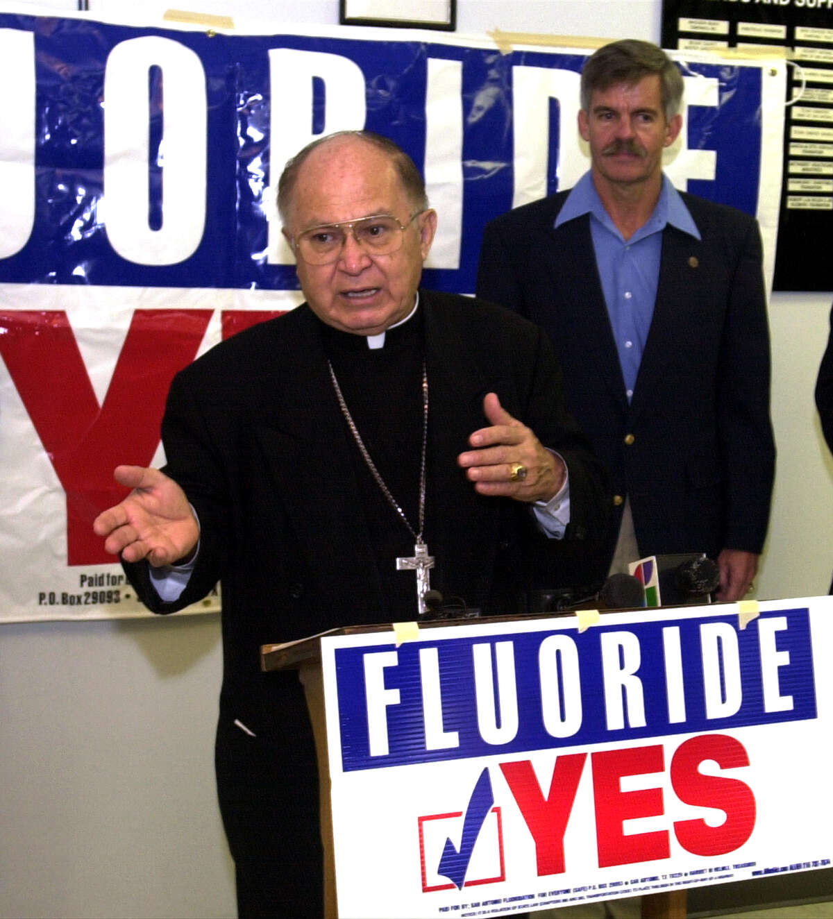 Archbishop Patrick Flores speaks about fluoride with Mayor Howard Peak at the Barrio Comprehensive Family Health Care Center. The bishop urged people to get out and vote.