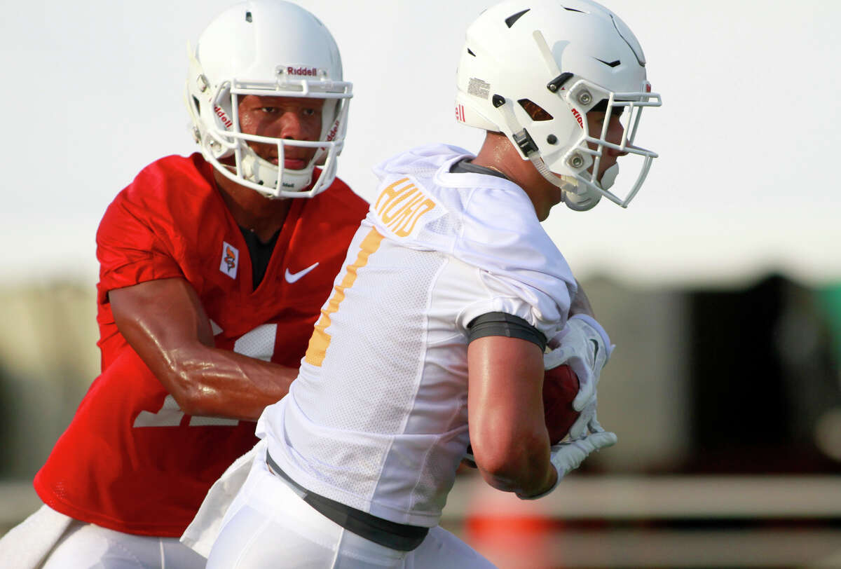 Tennessee quarterback Joshua Dobbs hands the ball to Jalen Hurd during the team's first NCAA college football practice of the season Tuesday, Aug. 4, 2015, in Knoxville, Tenn. (Daryl Sullivan/The Daily Times, via AP) MANDATORY CREDIT