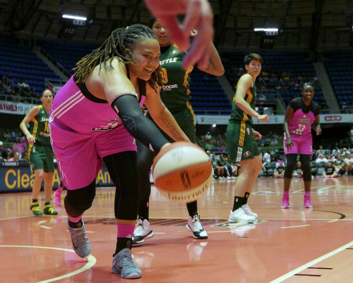 Danielle Adams of the San Antonio Stars reaches for a loose ball during WNBA action against the Seattle Storm at Freeman Coliseum on Saturday, Aug. 8, 2015.