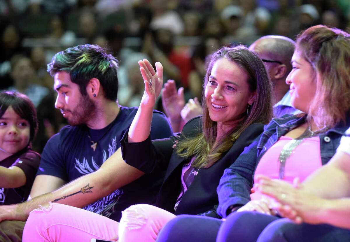San Antonio Spurs assistant coach and former San Antonio Stars basketball player Becky Hammon acknowledges applause as she is introduced during a timeout of the Seattle Storm versus Stars WNBA game at Freeman Coliseum on Saturday, Aug. 8, 2015.