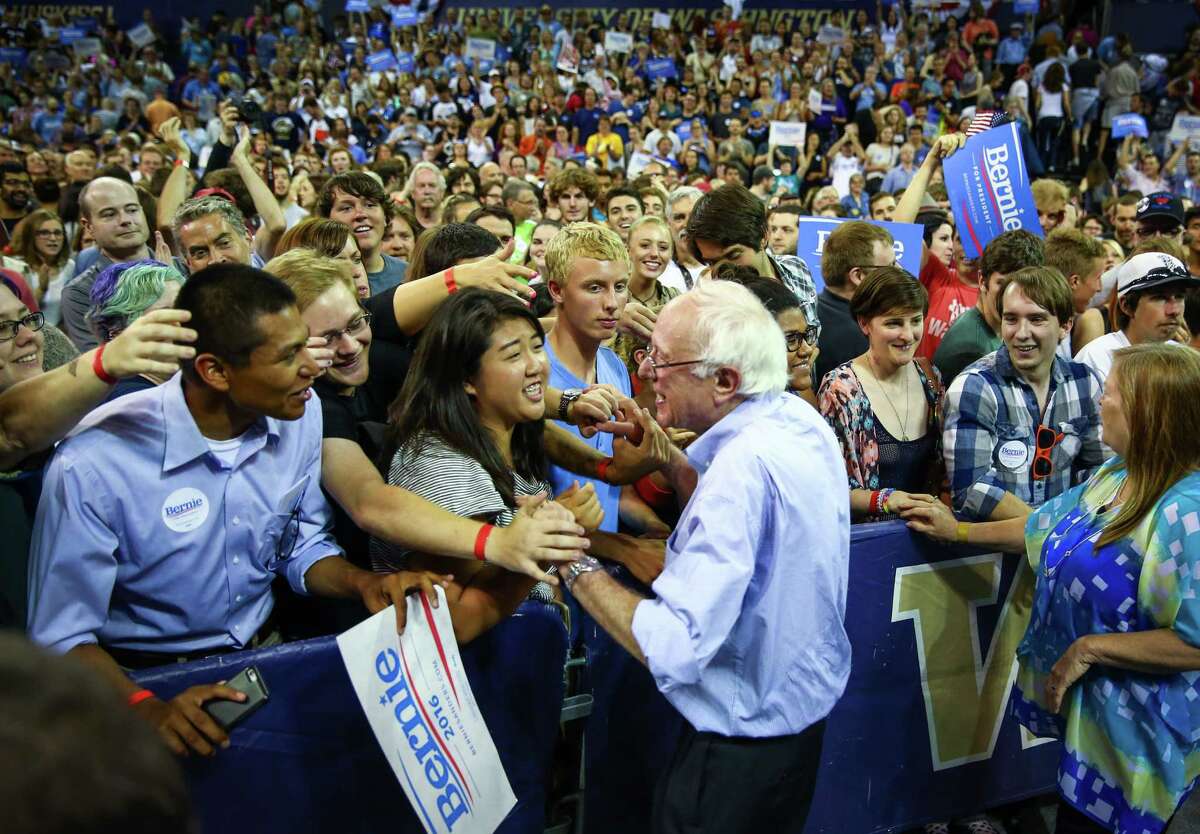 Bernie Sanders shakes hands with supporters during a rally at Hec Ed Pavilion that drew an estimated 15,000 people to the University of Washington. The rally filled the arena and left thousands outside. Earlier in the day Sanders participation in a rally at Westlake Park was cut short because protesters took over the microphone. Photographed on Saturday, August 8, 2015.
