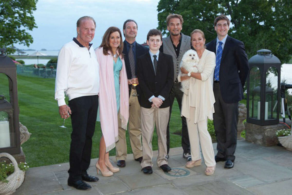Frank Gifford, left, and Kathie-Lee Gifford, at right holding a puppy, welcome the Marella family and singer/songwriter Kenny Loggins to their Riverside home where they were hosting the DART patrons cocktail party.