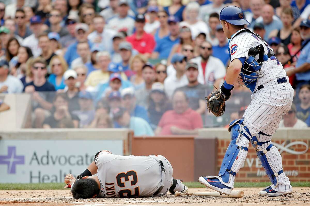Nori Aoki of the San Francisco Giants reacts after being hit in the head by a pitch thrown by Jake Arrieta #49 of the Chicago Cubs (not pictured) at Wrigley Field on August 9, 2015 in Chicago, Illinois.