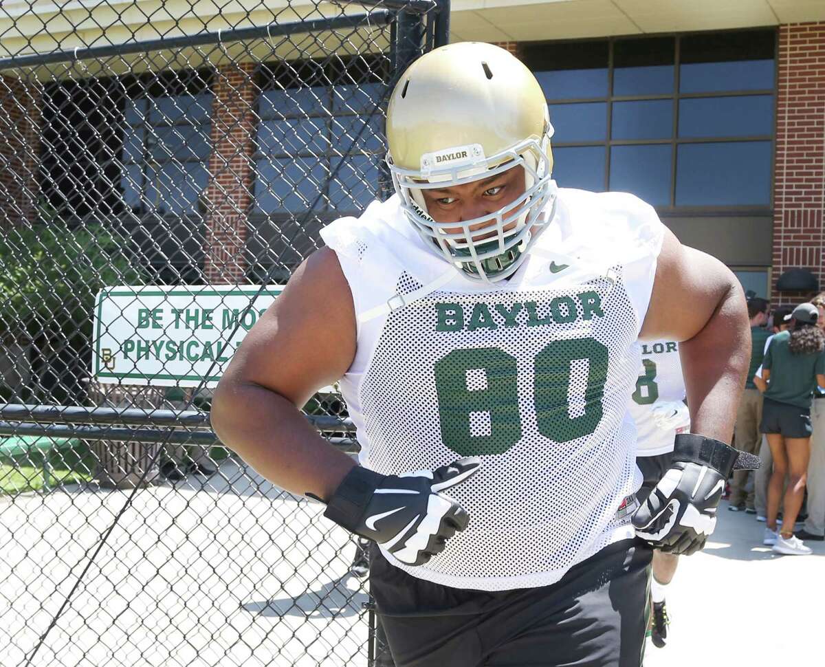 Baylor offensive lineman LaQuan McGowan heads to the field for the first day of practice on Aug. 6, 2015, in Waco.