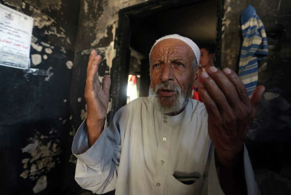 Mohammed Dawabsha prays at his deceased son’s destroyed home in the West Bank a day after the man’s funeral. Saad Dawabsha died eight days after his home was firebombed. His baby died instantly.