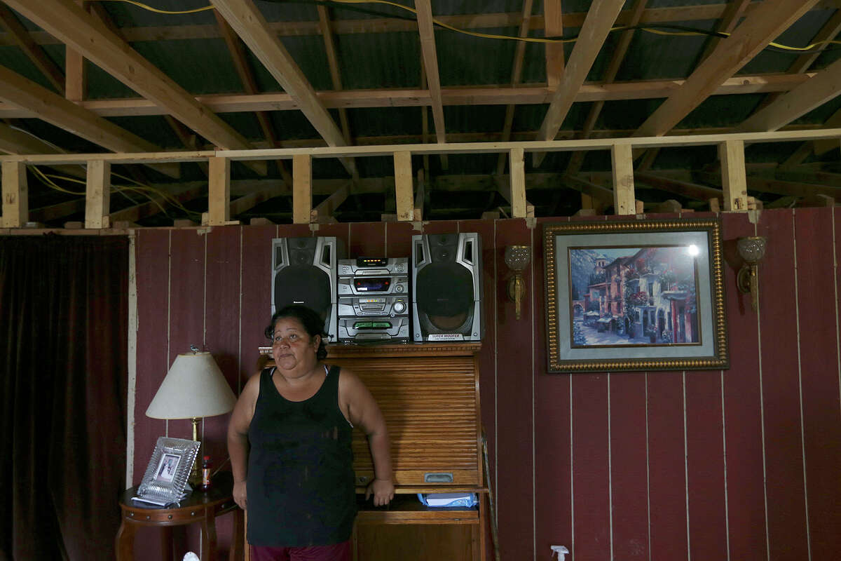 Maria De La Luz Gonzalez, 46, looks at an unfinished addition to her small two-room trailer in the Maize 5 colonia near Donna, Texas, Thursday, May 21, 2015. The room serves as the living room and kitchen. Gonzalez and her husband bought the half-acre plot in November of last year. The lots come with electrical and water hook ups that drove the price up. A plot of land that sold for $5,000 a decade ago might be sold for as much as $30,000 today, leaving low income families with little money to invest quality materials to build their homes, leading to new developments the Fed has dubbed the "new colonias." The family of four lived without electricity for a few months until they were able to afford the hook up fee. "This is my palace," she said.