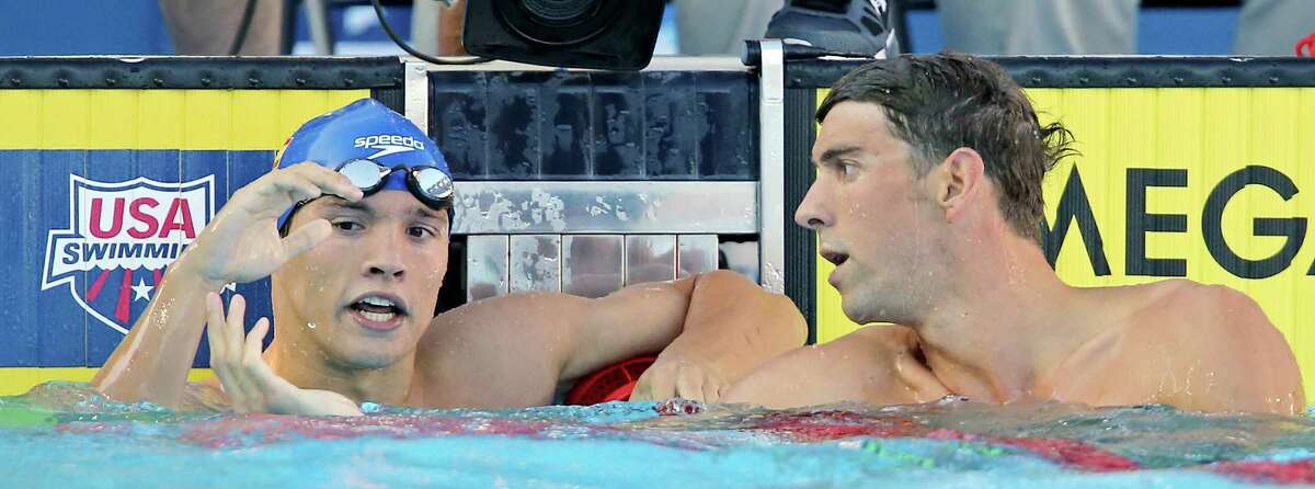 Eduardo Solaeche-Gomez (left) shakes hands with Michael Phelps after competing in the men's 200-meter individual medley during the 2015 Phillips 66 National Championships held Sunday Aug. 9, 2015 at the Northside Swim Center. Phelps finished first with a time of 1:54.75. Solaeche-Gomez finished fifth with a time of 1:59.81