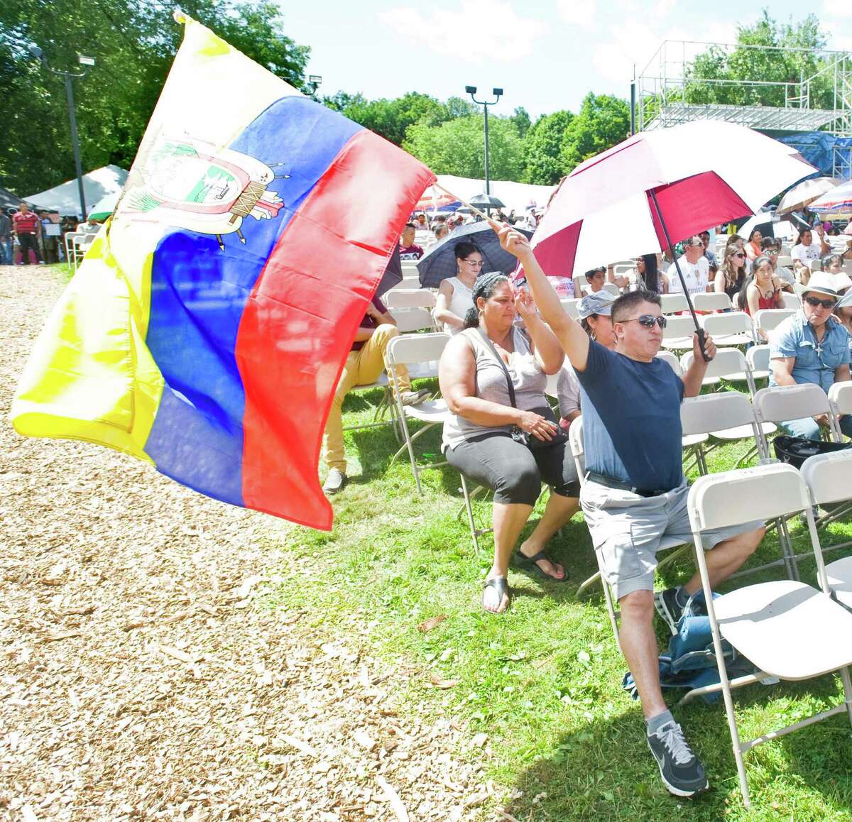 Angel Capon waves the flag of Ecuador at the annual Ecuadorian festival held at the Ives Concert Park in Danbury. Sunday, Aug. 9, 2015
