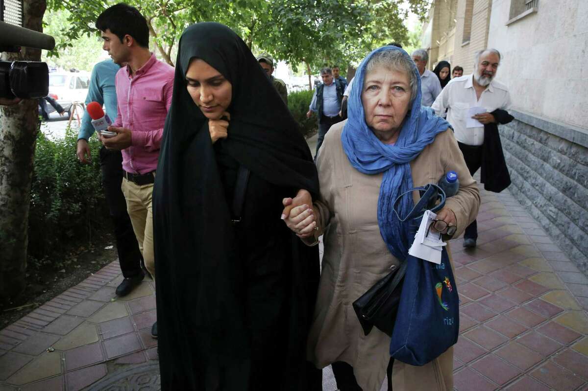 Mary Rezaian, mother of detained Washington Post correspondent Jason Rezaian, right, and Jason's wife Yeganeh leave a Revolutionary Court building in Tehran, Iran, Monday, Aug. 10, 2015. The final hearing of Rezaian detained in Iran more than a year ago and charged with espionage ended on Monday,with a verdict expected in the coming days in a trial that has been condemned by the newspaper and press freedom groups. (AP Photo/Vahid Salemi)