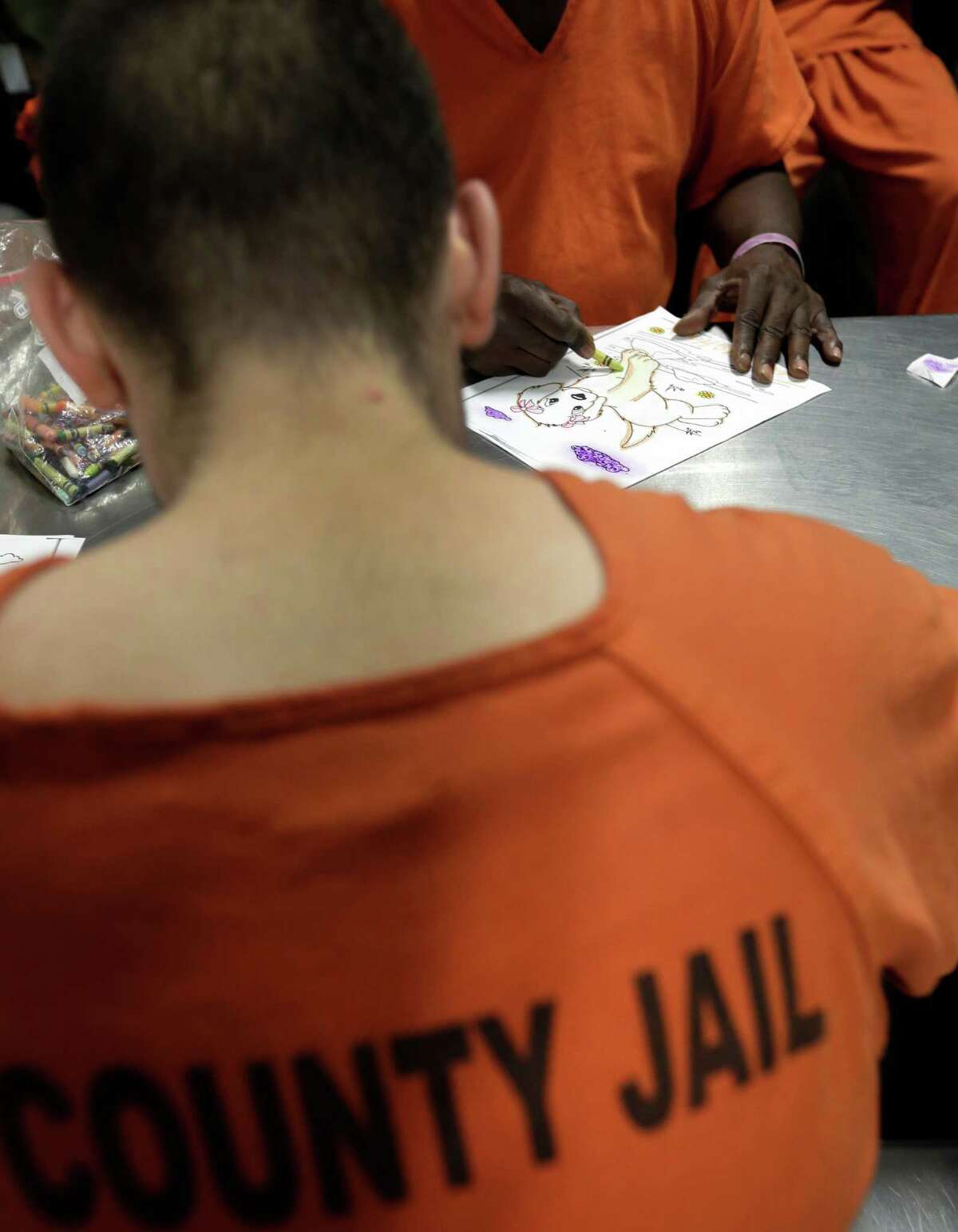 Inmates take part in a group therapy session in an acute unit of the mental heath unit at the Harris County Jail, Friday, Aug. 15, 2014, in Houston. (AP Photo/Eric Gay)