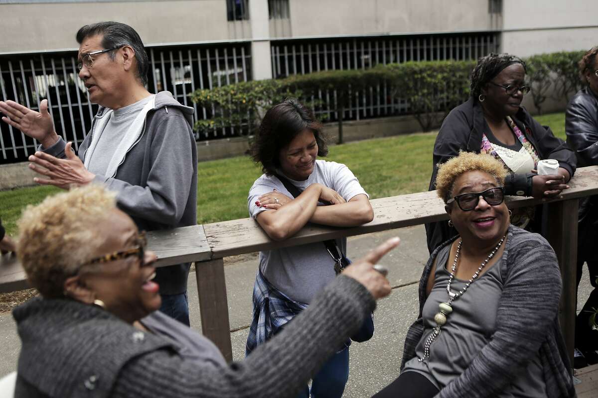 Neighbors talk together during a neighborhood barbecue at Midtown Park Apartments in San Francisco on Monday, Aug. 10, 2015. Residents have been trying to stick together as they fight the rising rent costs in the apartment complex.