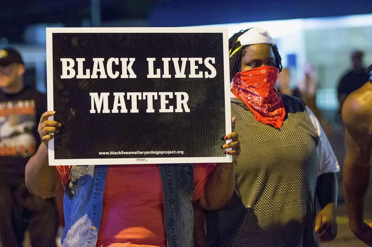 Demonstrators, marking the one-year anniversary of the shooting of Michael Brown, protest along West Florrisant Street on August 10, 2015 in Ferguson, Missouri.