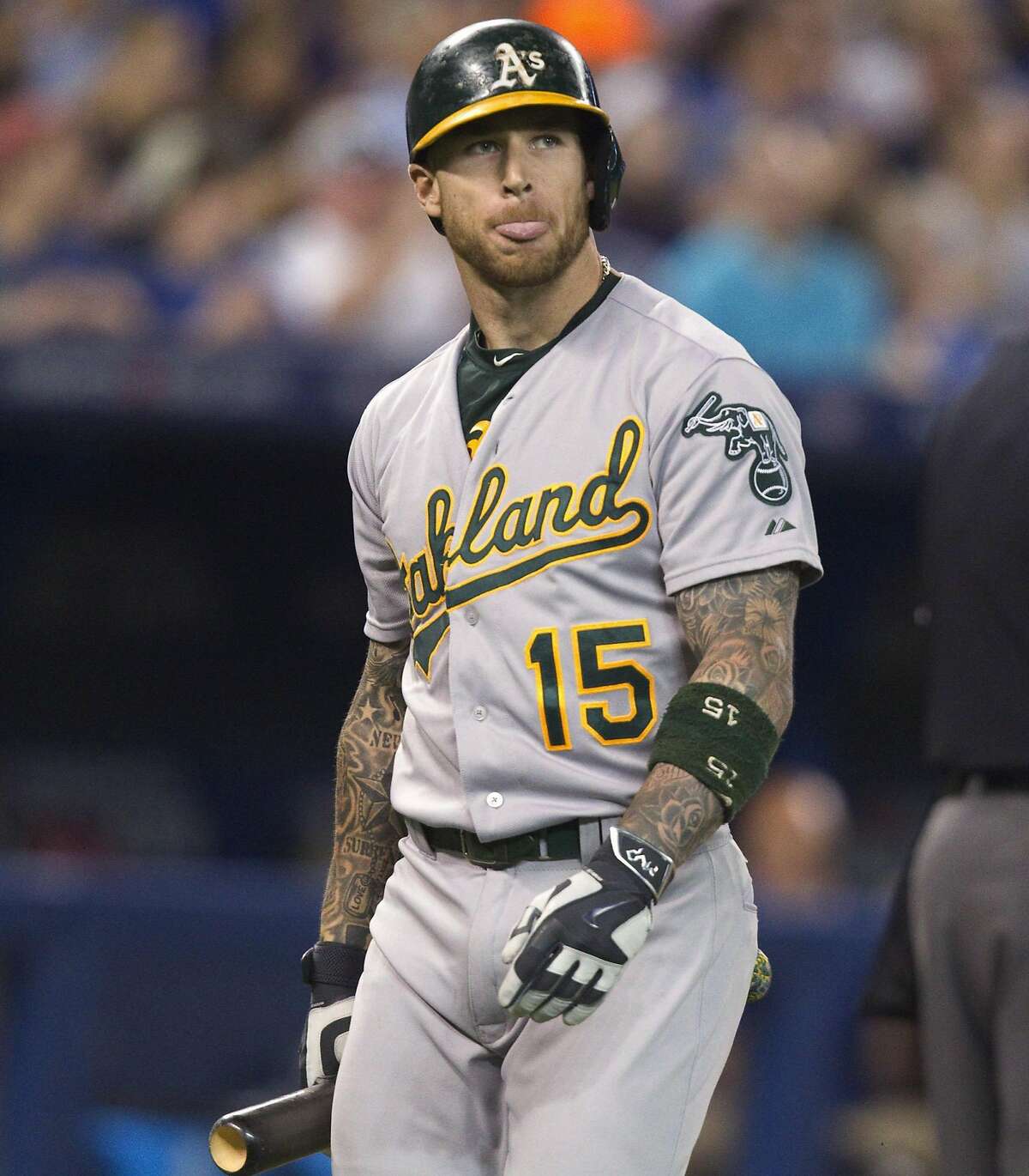Oakland Athletics' Brett Lawrie reacts after striking out during the seventh inning against the Toronto Blue Jays in a baseball game Tuesday, Aug. 11, 2015, in Toronto. Toronto won 4-2. (Fred Thornhill/The Canadian Press via AP)