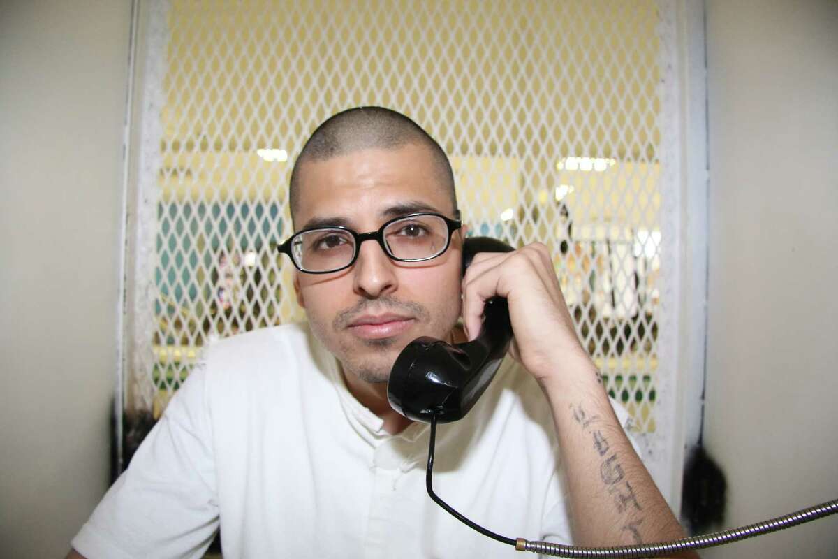 In this Aug. 5, 2015 photo, Daniel Lee Lopez, 27, speaks from a visiting cage outside death row at the Texas Department of Criminal Justice Polunsky Unit near Livingston, Texas.