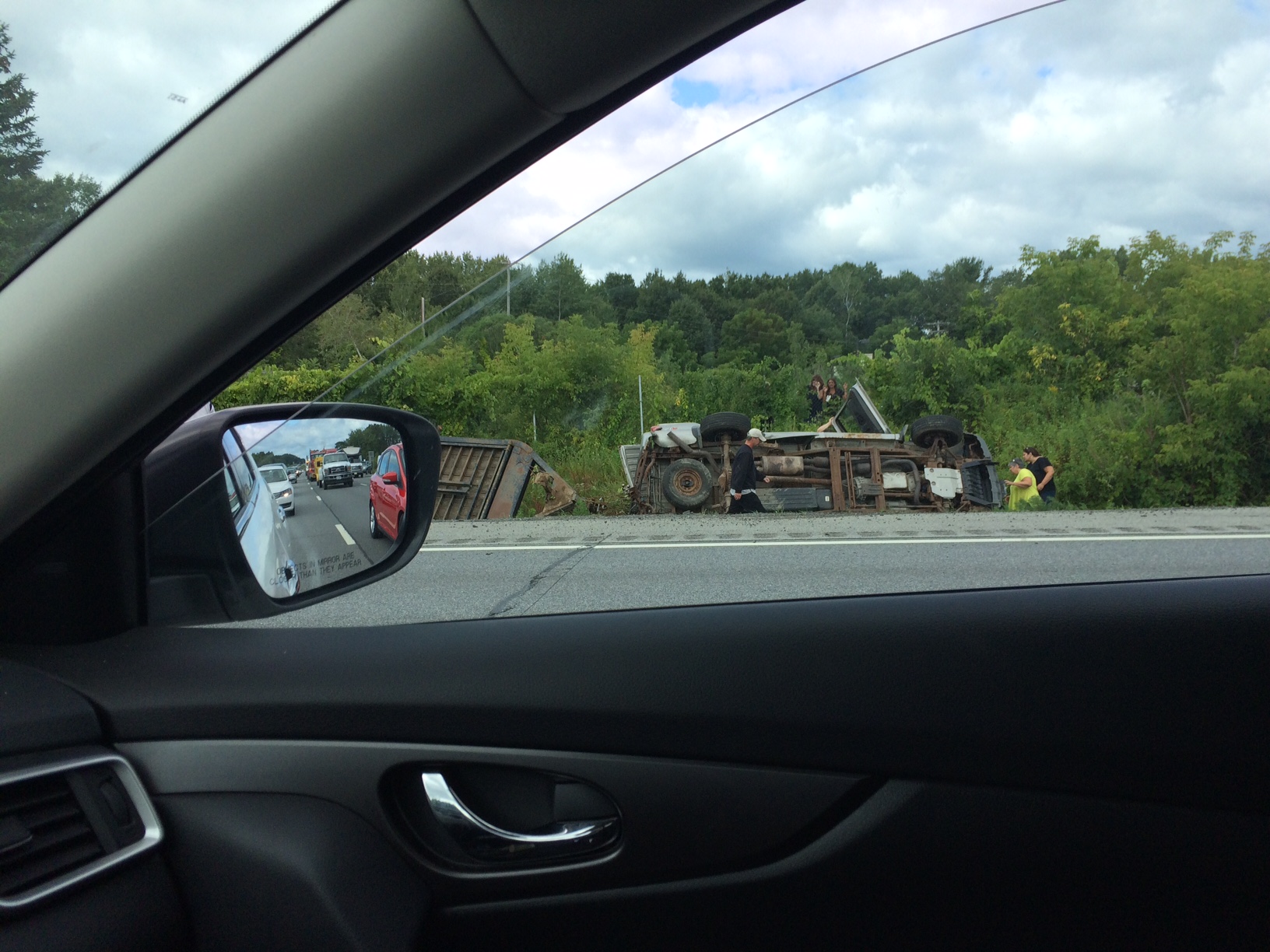 Tractor trailer rolls into ditch on Northway