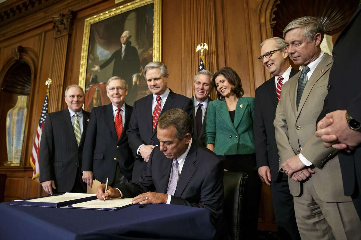 FILE - In this Feb. 13, 2015, file photo, House Speaker John Boehner of Ohio signs the bill authorizing expansion of the Keystone XL pipeline on Capitol Hill in Washington. For six and a half years, the White House has had a quick comeback to questions about its yet-to-be-announced decision on the proposed Keystone XL pipeline: Talk to the State Department. Under a President George W. Bush-era executive order, border-crossing oil pipelines require a presidential permit, granted only after a government-wide review coordinated by the State Department. An Associated Press review of every cross-border pipeline application since 2004 shows that the Keystone review has been anything but ordinary. Senate sponsor of the Keystone XL pipeline bill, Boehner, House Majority Leader Kevin McCarthy of Calif., Rep. Kristi Noem, R-S.D., Rep. Kevin Cramer, R-N.D., and House Energy and Commerce Committee Chairman Rep. Fred Upton, R-Mich. (AP Photo/J. Scott Applewhite, File)