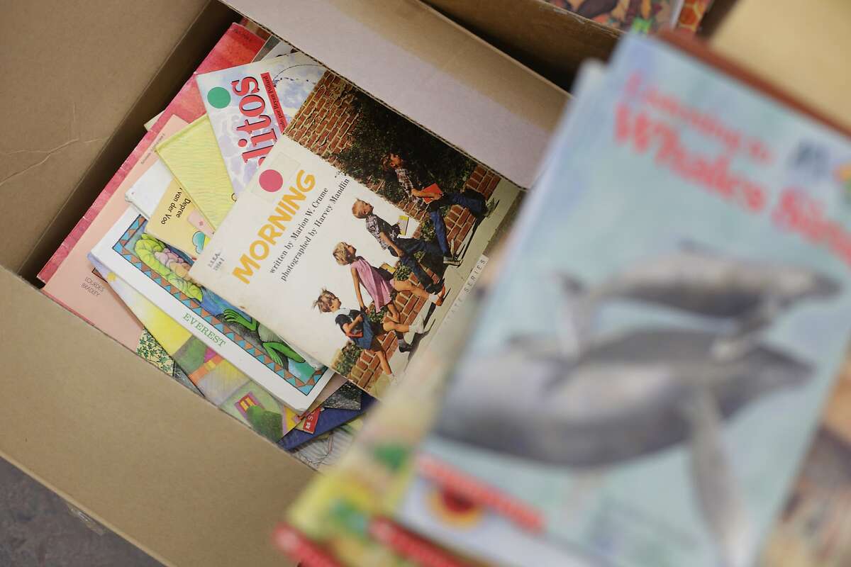 Books that new SFUSD teacher Ashli Duncan acquired for her second grade classroom sit in a box next to other books given to her from an outgoing teacher at Bessie Carmichael Elementary School on Wednesday, August 12, 2015 in San Francisco, Calif.