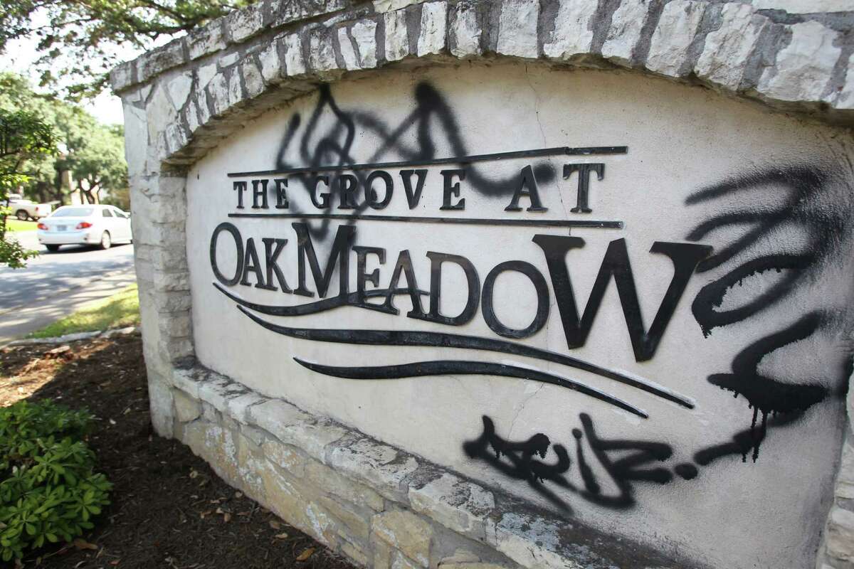 Racially biased graffiti is visible on the community entrance sign at The Grove at Oak Meadows where vandals sprayed racial epitaphs and language on numerous cars, homes and other community markers near a Jewish Orthodox community.