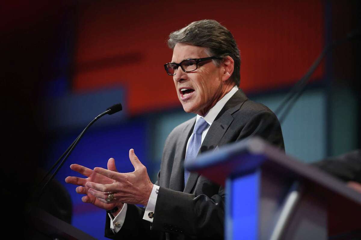 Rebulican presidential candidate Rick Perry’s campaign is virtually out of money and he has quit paying staffers. A super PAC is assembling other staff to pick up the slack, leading to questions about coordination. Here, Perry fields a question during a presidential forum hosted by FOX News and Facebook at the Quicken Loans Arena on Aug. 6.