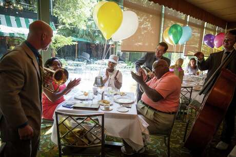 L-R, seated: Lauren Harper, 25, parents Rocklyn Harper, 58, and Howard Harper, 65, all of Houston, enjoy a jazz brunch at Commanders Palace in New Orleans on August 2, 2015.
