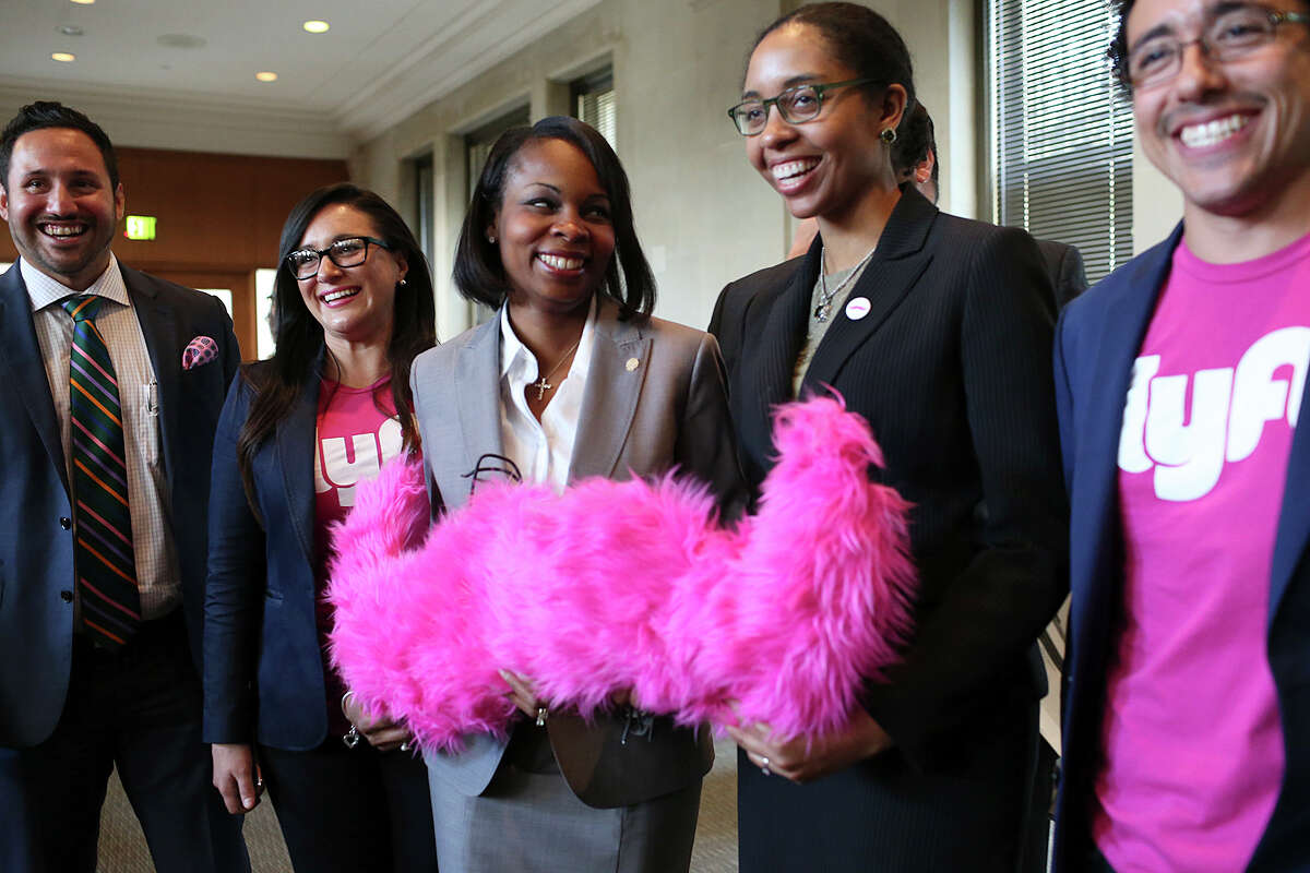 Mayor Ivy Taylor, center, poses with Lyft representatives after the San Antonio City Council votes to approve a nine-month pilot ride-hailing program with Lyft on August 13. The council voted 6-5, with council members Rebecca Viagran, Shirley Gonzales, Ray Lopez, Cris Medina, Mike Gallagher dissenting. Council members Roberto Trevino, Alan Warrick, Rey Saldana, Ron Nirenberg, Joe Krier and Mayor Ivy Taylor voted to approve the program. With Taylor is Lyft Public Policy Manager April Mims, second from right. Also in the group are OCI Group's representing Lyft, from left, Luis Gonzalez, Olivia Travieso and Jose Vidal.